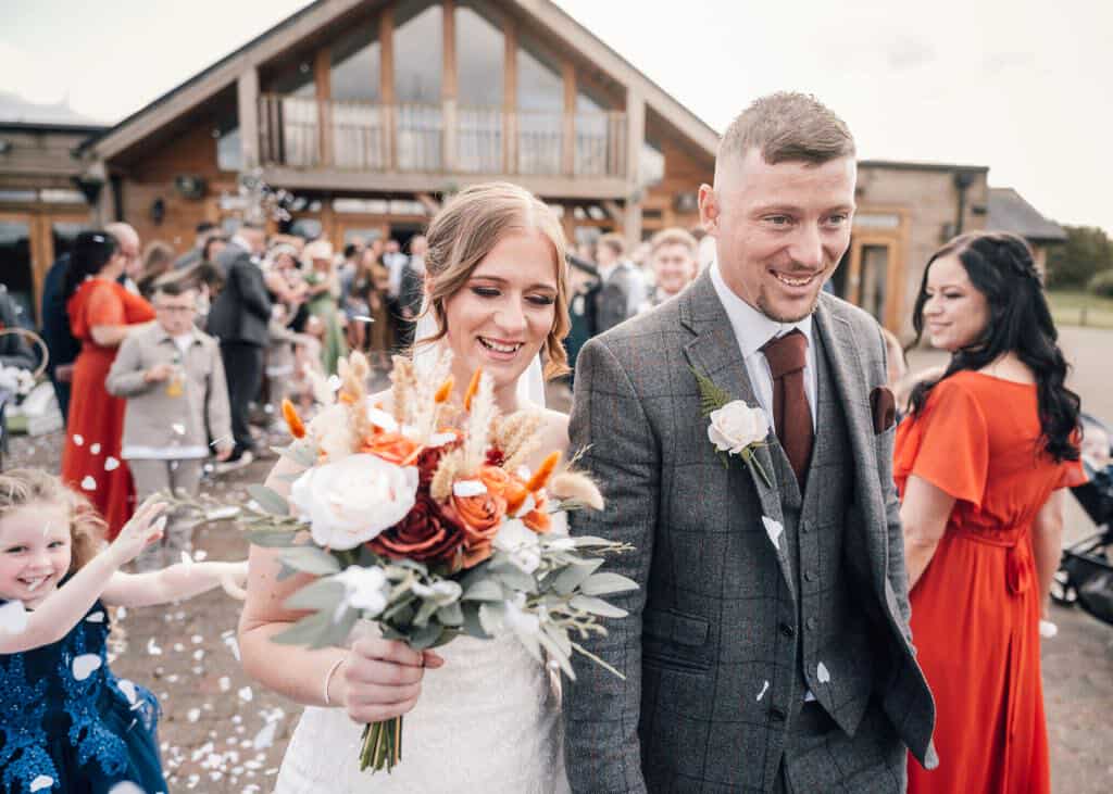 Happy customer holding floral arrangement from Making It Bloom